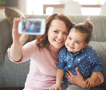 Mother and daughter taking self picture